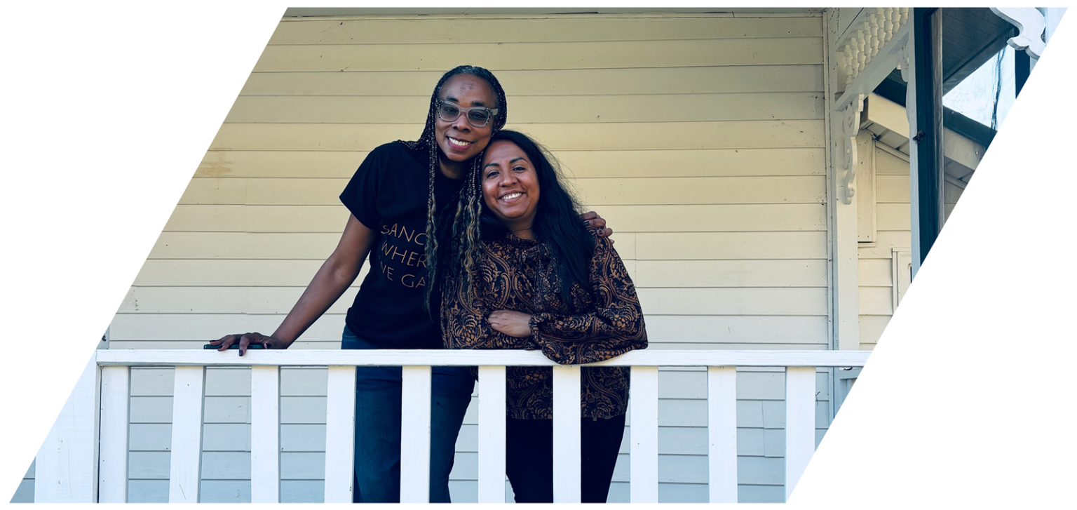 Two women business owners smiling together.